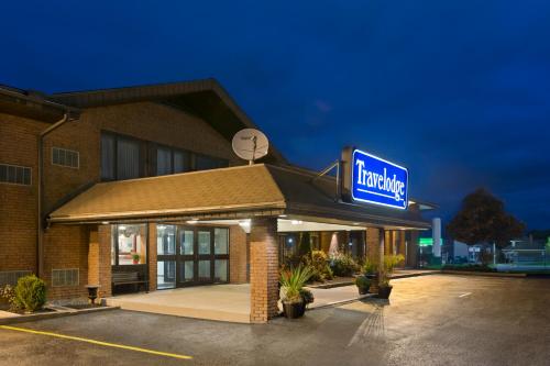a large building with a clock on the front of it at Travelodge by Wyndham Owen Sound ON in Owen Sound