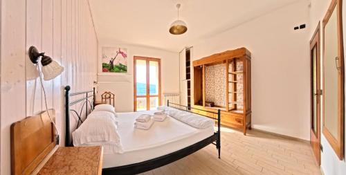 a bedroom with a bed and a window at Villa Arianna Lake View Apartments with Pool in Tignale