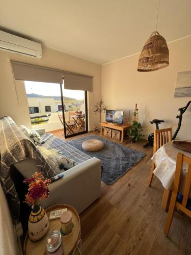 a living room with a couch and a table at Casa das Oliveirinhas in Alvor