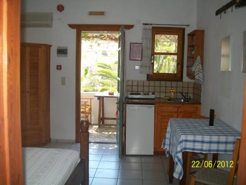 a kitchen with a table and a sink and a stove at PATMOS Mathios Studios- apartments in Patmos