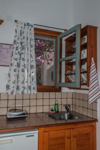 a kitchen with a sink and a window at PATMOS Mathios Studios- apartments in Patmos