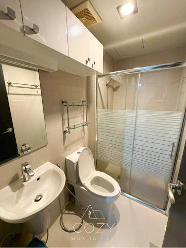 a bathroom with a toilet and a sink and a shower at Studio Unit in Manhattan Heights with Balcony in Sampong