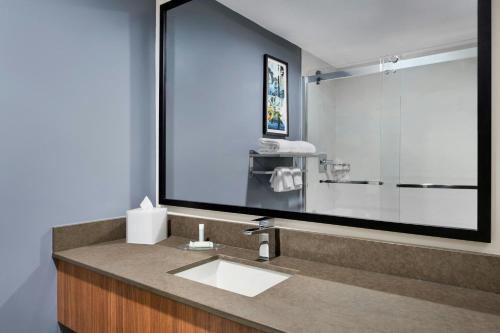 a bathroom with a sink and a large mirror at Fairfield Inn & Suites San Diego Old Town in San Diego