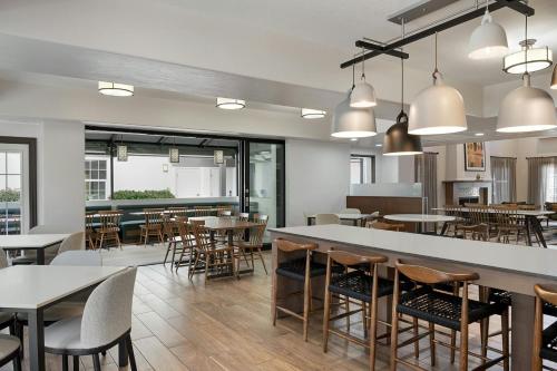 a restaurant with tables and chairs and a bar at Fairfield Inn & Suites San Diego Old Town in San Diego