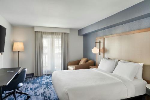 a hotel room with a large bed and a desk at Fairfield Inn & Suites San Diego Old Town in San Diego