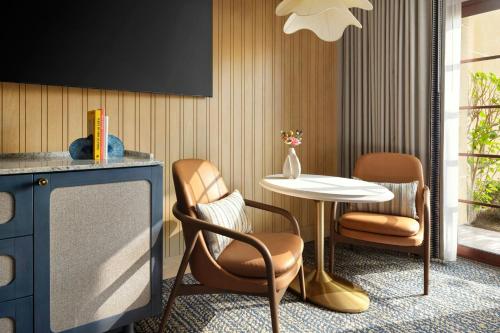 a room with a table and two chairs and a table at Hotel Solea, Autograph Collection in Carlsbad