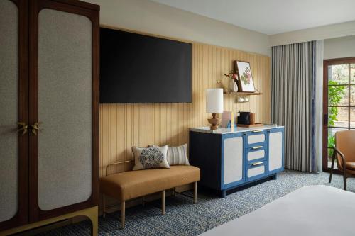 a hotel room with a bed and a chair at Hotel Solea, Autograph Collection in Carlsbad