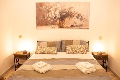 a bedroom with a bed with two towels on it at La Cortese, cuore barocco in Noto
