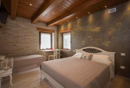 a bedroom with a bed and a bench in a room at B&B Olmo in Saludecio