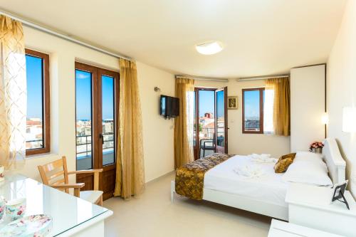 a hotel room with a bed and a balcony at Polyxenia Suites in Rethymno