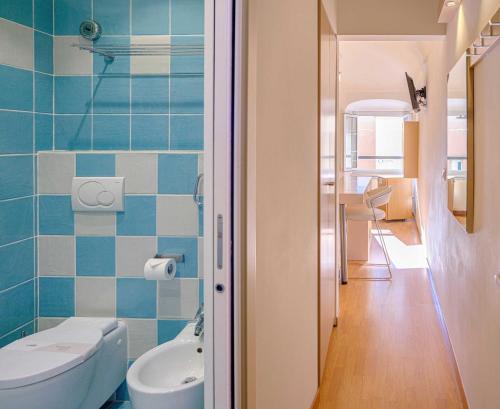a bathroom with a toilet and a sink at Hotel Melograno in Spotorno