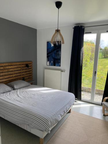 a bedroom with a bed and a large window at Appartement RDC quartier calme in Saint-Dizier