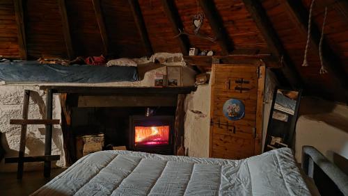 a bedroom with a bed and a fire in a fireplace at Rifugio Ortobene in Nuoro