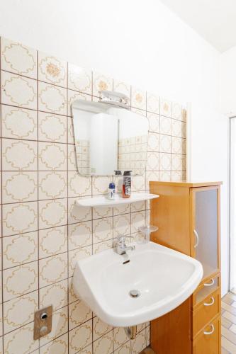 a bathroom with a sink and a mirror at Vacation, Work, Party in Allerstorf