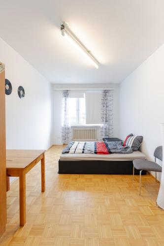 a bedroom with a bed in the middle of a room at Vacation, Work, Party in Allerstorf