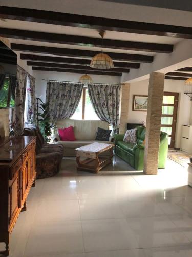 a living room with a couch and a table at Casa Cu Lavandă in Valea Drăganului
