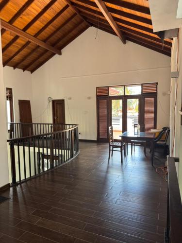 a dining room with a table and chairs in a room at Perera Tree Villa in Ja-Ela