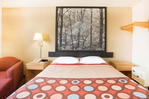a small room with a bed and a window at Super 8 by Wyndham Lexington VA in Lexington
