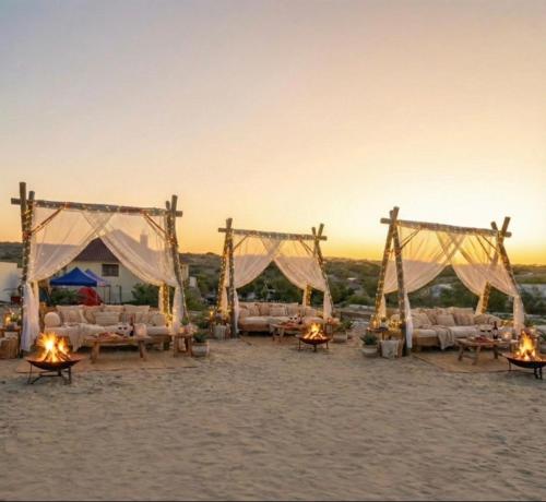 an outdoor wedding with couches and candles on the beach at Maan Resort in Mogadishu