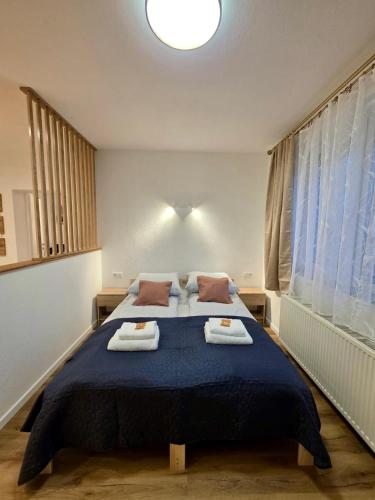 a bedroom with a large bed with towels on it at Ferienwohnung "Wohnung in Haus" in Neunkirchen
