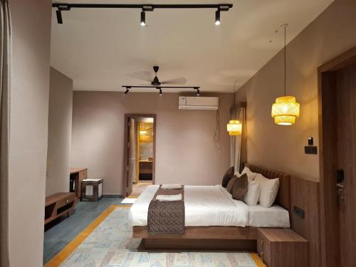 a bedroom with a large bed in a room at Kayo Resort Pench in Seonī