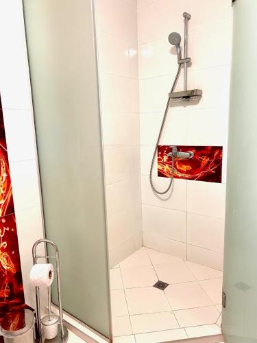 a shower with a glass door in a bathroom at Villa Amity in Varna City