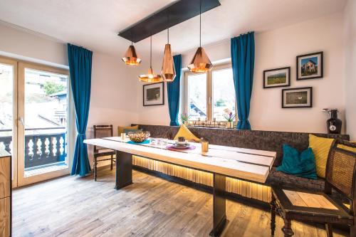 a living room with a table and a couch at Blackriver Lodge Saalbach in Saalbach-Hinterglemm