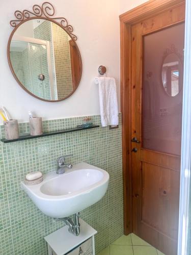 a bathroom with a sink and a mirror at Cozy 18th century house in San Gimignano