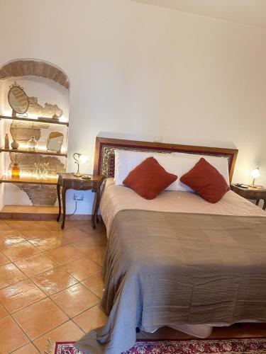 a bedroom with a bed with two pillows on it at Cozy 18th century house in San Gimignano