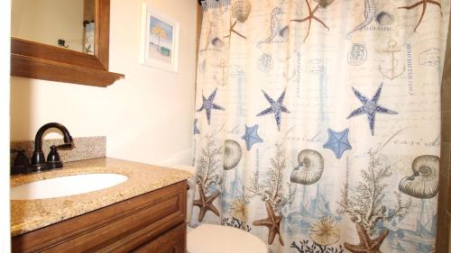 a bathroom with a shower curtain with stars on it at Relaxing Beginnings in Cape May Point