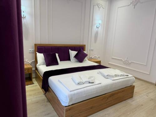 a bedroom with a large bed with two towels on it at Amir Mumtoz Boutique hotel in Bukhara