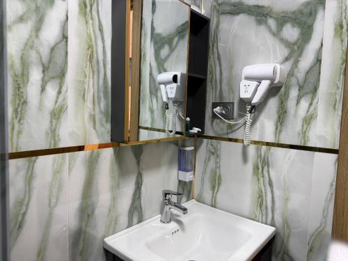 a bathroom with a sink and a mirror at Amir Mumtoz Boutique hotel in Bukhara