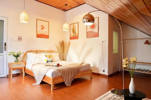 a bedroom with a bed in a room at Green Meadow Serenity - Center Hotel in Da Lat