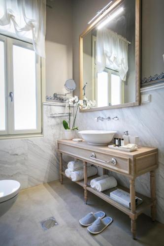 a bathroom with a sink and a mirror at 1905 Boutique Hotel in Xanthi