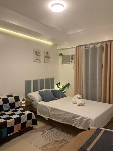a bedroom with two beds and a couch at Bright Nook in Manila