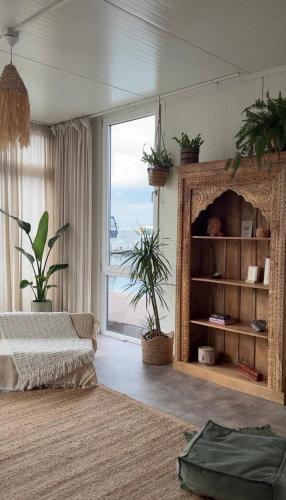 a living room with a bed and a large window at RetreatBoat Bali in Lithoijen