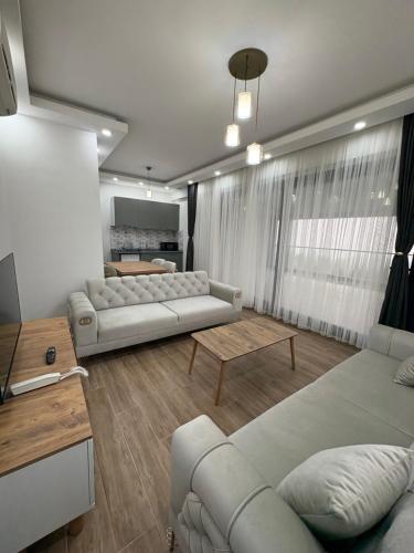 a living room with two couches and a table at Lale Saray Sapanca in Sapanca