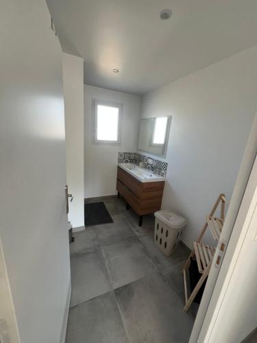a bathroom with a sink and a toilet at Gîte de la Nolière in La Lande-Saint-Siméon