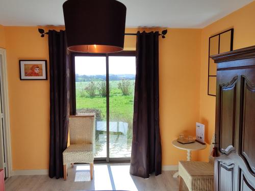 a room with a large window with a view at Chez Herveline Le Fer - Chambres et table d'hôtes in Plouigneau