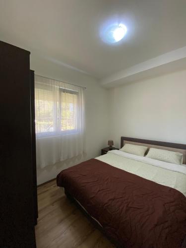 a bedroom with a large bed and a window at Bela Rada in Tivat