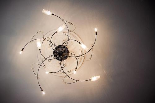 a chandelier with lights hanging from the ceiling at 4 Couples & 4 Friends Hostel in Krakow