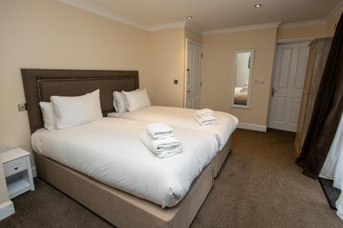 a bedroom with a bed with towels on it at Terlingham Lane Cottage in Folkestone