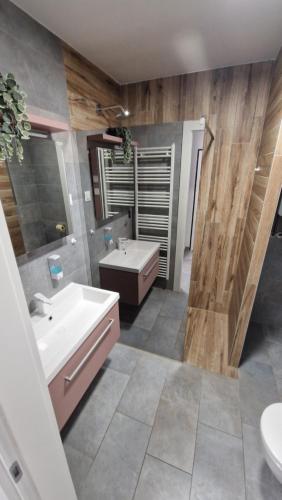 a bathroom with a sink and a tub and a toilet at XYZ-Osijek in Osijek