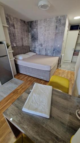 a small room with a bed and a table at XYZ-Osijek in Osijek