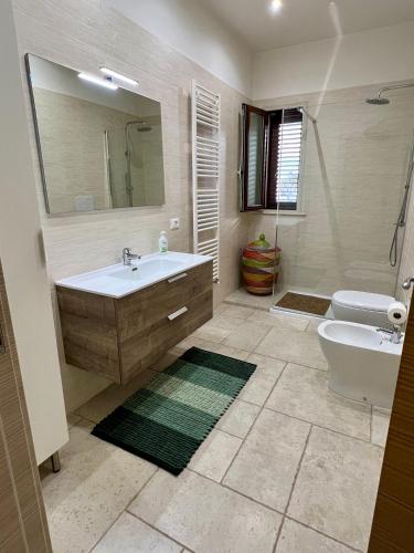 a bathroom with a sink and a toilet and a mirror at MASSERIA FRANTELLA in Grottaglie