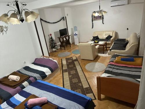 a living room with three beds and a couch at Hostel Struga in Struga