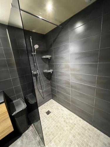 a shower with a glass door in a bathroom at Gîte de Charme in Saint-Avit-de-Tardes