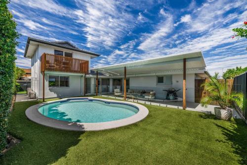 a house with a swimming pool in the yard at Mooloolaba Canal Retreat with Pool Sleeps 12 in Mooloolaba
