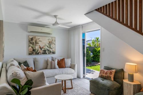 a living room with a couch and a table at Mooloolaba Canal Retreat with Pool Sleeps 12 in Mooloolaba