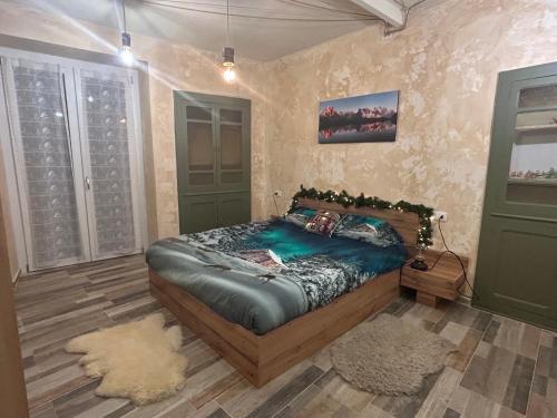 a bedroom with a bed and two green doors at Il caminetto in Pradleve